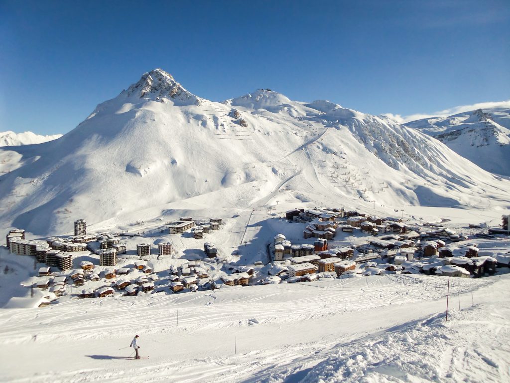 Ski resort of Tignes in winter, ski slope and village of Tignes le lac in the background