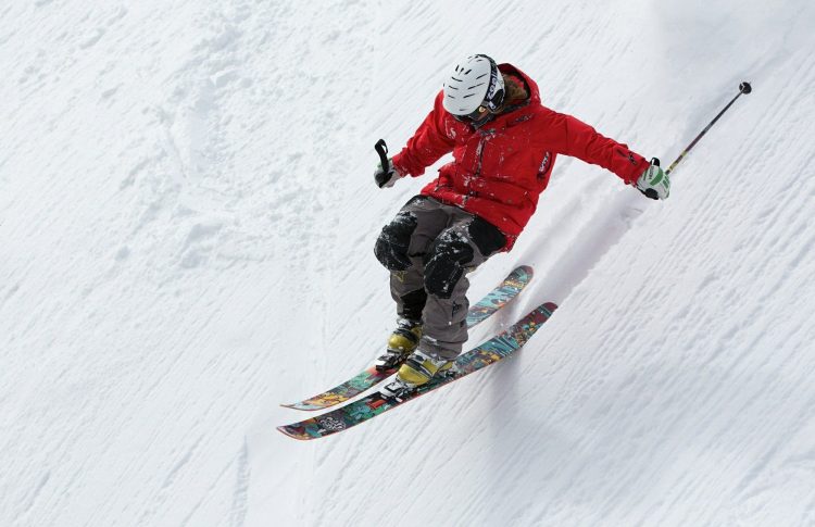 Man skiing down a steep ski slope